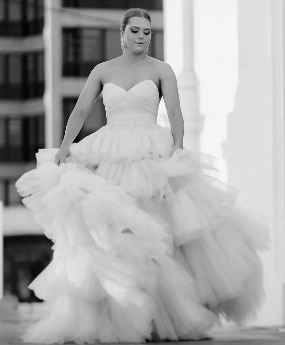 V-neck strapless dress with 5 tiered voluminous tulle skirt with open V back