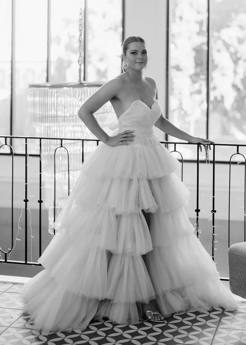 V-neck strapless dress with 5 tiered voluminous tulle skirt with open V back